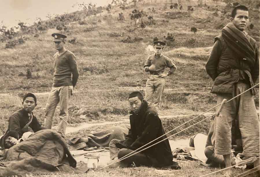 Avery White at the back of the photo. Written on the back Guerilla soldiers after their surrender to British soldiers when Japs pushed them over British Territory. Taken not long before Avery White's capture.
