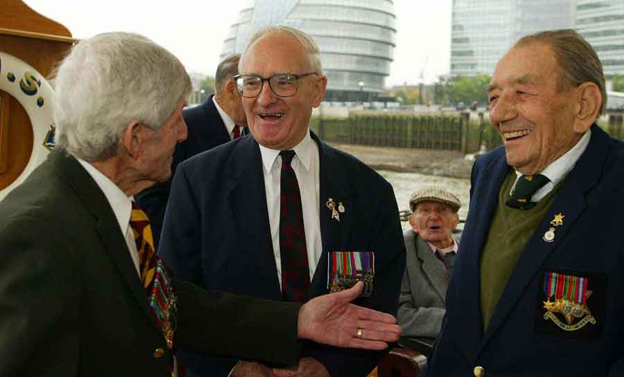 Reunion of survivors of the sinking of the Lisbon Maru on HMS Belfast. Charles Jordan is on the far right. Can you name any of the other men in this picture?