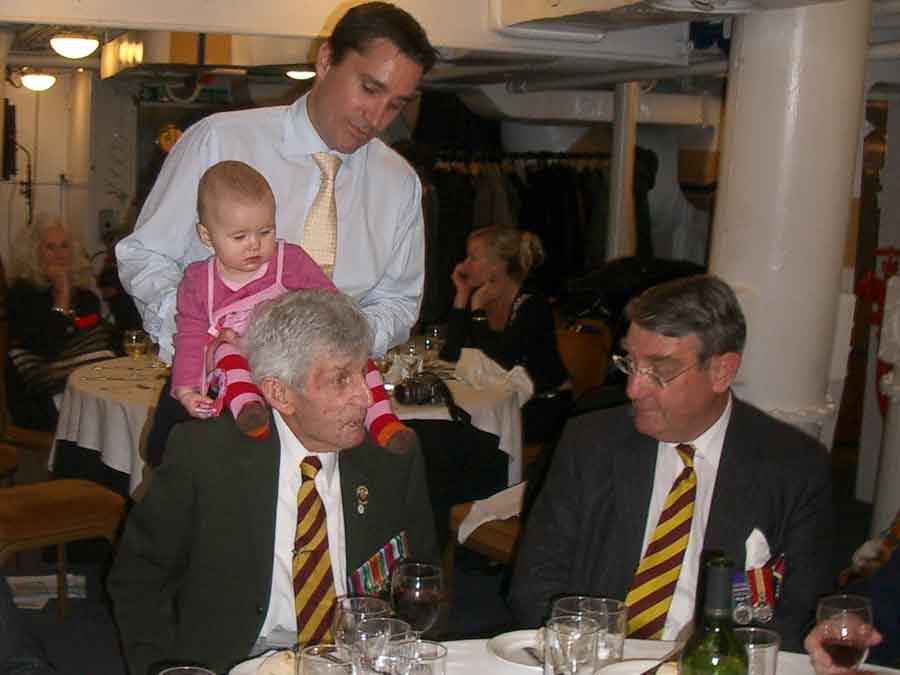 Reunion of survivors of the sinking of the Lisbon Maru on HMS Belfast. Brian Finch is on the right. Can you name any of the other men in this picture?