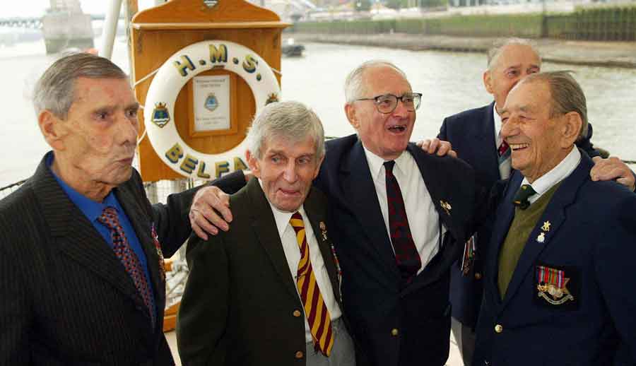 Reunion of survivors of the sinking of the Lisbon Maru on HMS Belfast. Charles Jordan is on the far right. Can you name any of the other men in this picture?