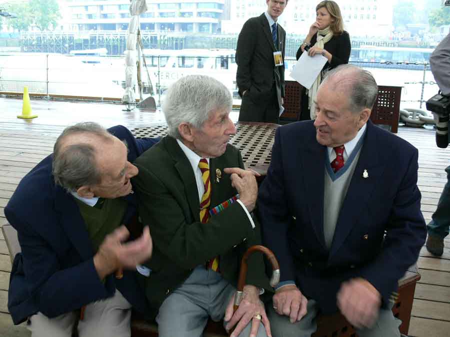Reunion of survivors of the sinking of the Lisbon Maru on HMS Belfast. Can you name any the men in this picture?